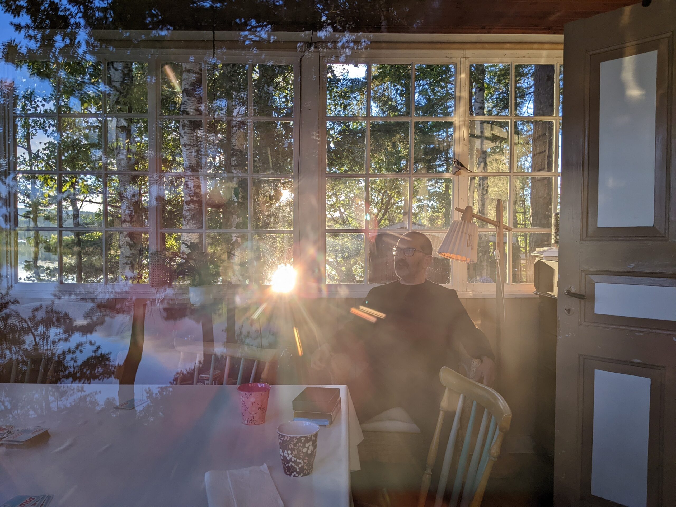 Venanzio sitting by a window in a cabin in Sweden